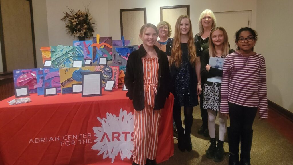 Pictured here are a few of the students who took part in an art project inspired by “Vitality,” a new work performed by the Adrian Symphony Orchestra at its Nov. 12 concert. From left to right are Ashlyn Strouss; Adrian Center for the Arts instructor Taina Mantey; composer Gala Flagello; instructor Michele Pisano Spence; Arleigh Brooks; and Olivia Bosquez.